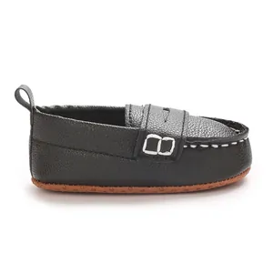 Detailed side view of black soft-soled faux leather baby loafer with white stitching