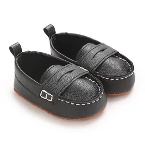 Close-up of black baby leather loafers with white stitching and soft anti-slip soles