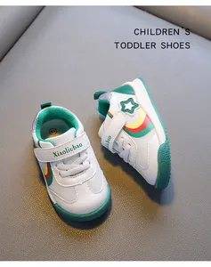 Breathable white toddler walking shoes with green accents and velcro strap closure.