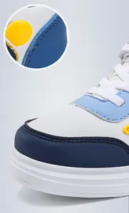Detail macro view of boys' leather sports sneakers featuring premium stitching and durable texture