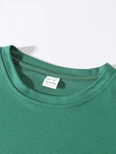 Nahaufnahme des grünen Mesh-Sport-Tanktops am Ausschnitt mit Größenetikett.