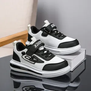 Stylish boys' black and white sports sneakers with durable leather upper and velcro strap