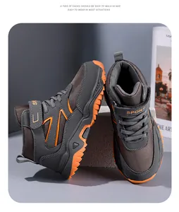 Close-up of durable high-top kids hiking shoes with orange tread soles and velcro strap
