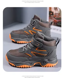Side detail of kids' high-top hiking shoes with breathable mesh and orange anti-slip soles.