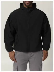 Close-up detail of a black hooded windproof outdoor jacket worn by a male model