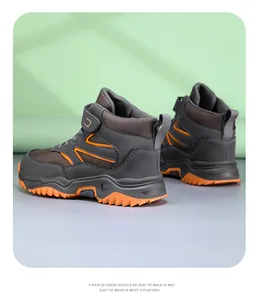 Detail of durable high-top children's outdoor hiking shoes with orange anti-slip sole