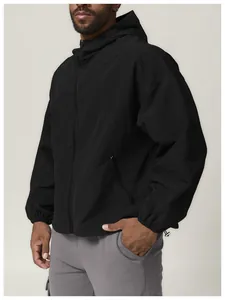 Close-up of a men's black hooded windbreaker jacket for outdoor hiking and camping