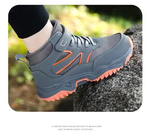 Close-up of boys high-top outdoor hiking shoes with rugged orange sole