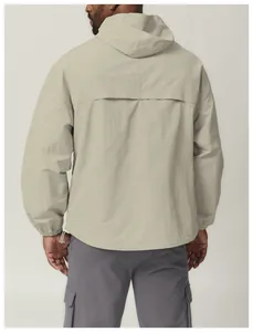Back view of a lightweight beige hooded windbreaker with adjustable hem detail