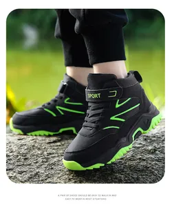 Detail view of high-top children's hiking shoes in black and neon green for outdoor sports