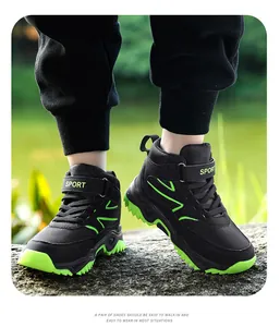 Detailed view of kids' high-top hiking shoes with black and neon green breathable mesh