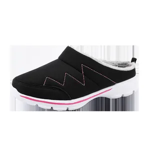 Detail shot of black winter mules with pink zigzag stitching and faux fur lining