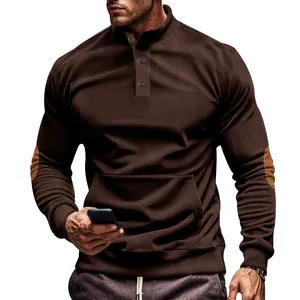 Detail view of men's brown corduroy sweatshirt with buttoned stand collar and pocket