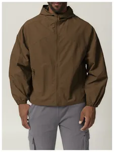 Detail view of a brown hooded windproof jacket with zip-up front for outdoor use