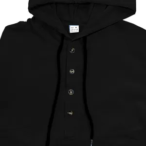 Detail view of a black men's hooded cotton shirt featuring brown buttons and a neck tag
