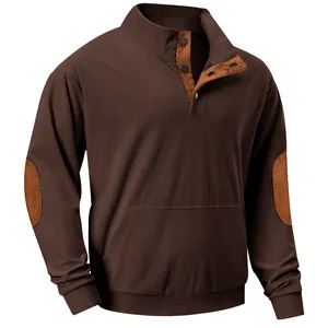 Detail of men's brown corduroy sweatshirt featuring button collar and elbow patches