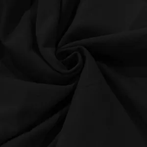 Close-up macro detail of black cotton linen fabric texture showing natural soft folds