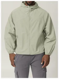 Front view detail of a sage green windproof hooded outdoor hiking jacket for men