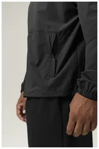 Close-up detail of hidden zipper pocket on a premium black water-repellent sports jacket