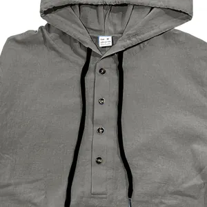 Detail view of men's cotton linen hooded shirt with buttons and drawstrings