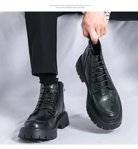 Close-up of men's black leather Martin boots with thick soles and side zippers