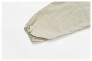 Macro close-up detail of elasticated cuff on beige windproof outdoor hiking jacket