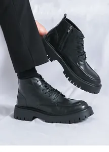 Detailed side view of premium black leather high-top Martin boots with thick lug platform sole