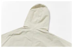 Detailed close-up showing the hood and shoulder stitching of a beige windproof outdoor jacket