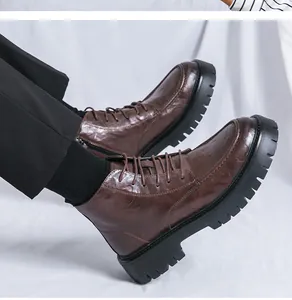Detailed side view of men's brown leather work boots with thick lug soles and side zipper.