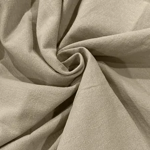 Macro detail of beige cotton linen fabric showing natural fiber texture and soft folds