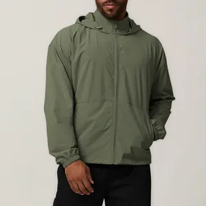 Detailed view of an olive green men's hooded windbreaker jacket with water repellent fabric.