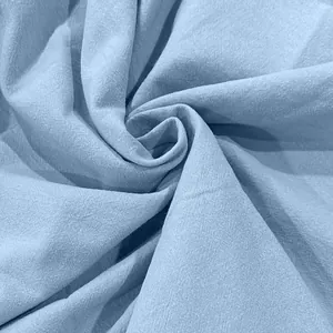 Macro view of light blue cotton linen fabric showing detailed weave and soft texture.