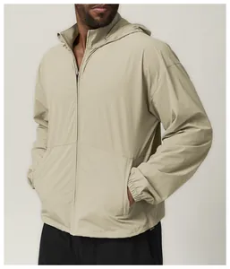 Detail view of men's lightweight water-repellent khaki hooded jacket with front zipper