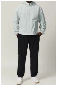 Detail view of men's sun-protective water-repellent hooded windbreaker in light grey