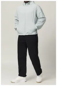 Detail view of men's water-repellent hooded sports windbreaker jacket in light grey