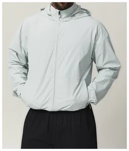 Close-up detail of a men's mint green water-resistant hooded windbreaker jacket