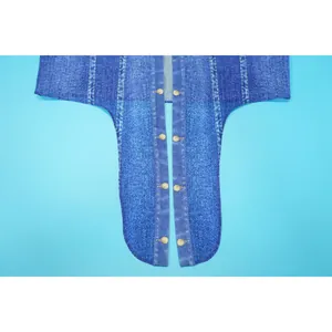 Detailed macro view of denim-print chiffon fabric featuring decorative gold-tone buttons