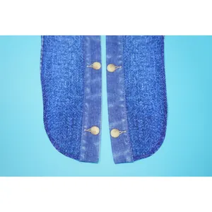 Detailed view of blue denim print chiffon fabric featuring classic round bronze buttons