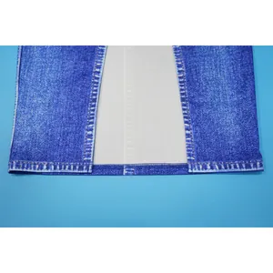 Close-up detail of faux denim print fabric and hem stitching for women's outfit.