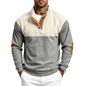 Close-up of men's color-block corduroy sweatshirt with stand collar and button detail.