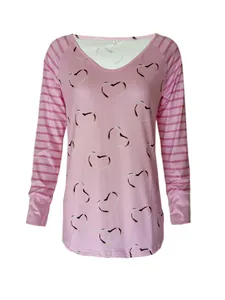Close-up of pink long-sleeve T-shirt featuring heart prints and striped sleeves.