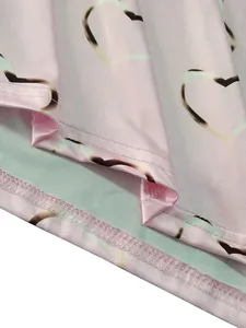 Macro view of pink heart print fabric showing high-quality stitching and mint green lining