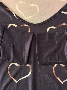 Detailed close-up of heart print pattern on dark plus size long sleeve T-shirt for women