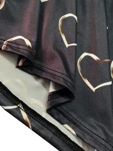 Close-up of heart print and hem stitching on charcoal gray long sleeve T-shirt