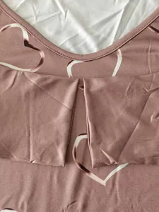 Detailed macro view showing the heart pattern and stitching on a mauve plus size t-shirt