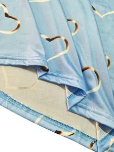 Close-up view of double-needle stitching and heart pattern on blue long sleeve T-shirt
