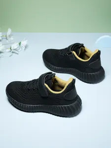 Detailed side view of breathable black and yellow kids' lightweight running shoes
