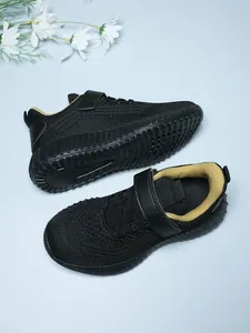 Detailed view of black breathable mesh kids' running shoes with yellow lining