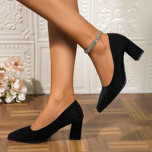 Detail of elegant black pointed-toe chunky high heel pumps for professional women's wear
