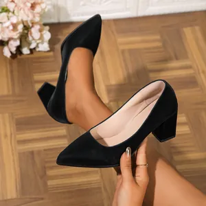 Elegant black pointed-toe block heel pumps shown from a side detail view on a model
